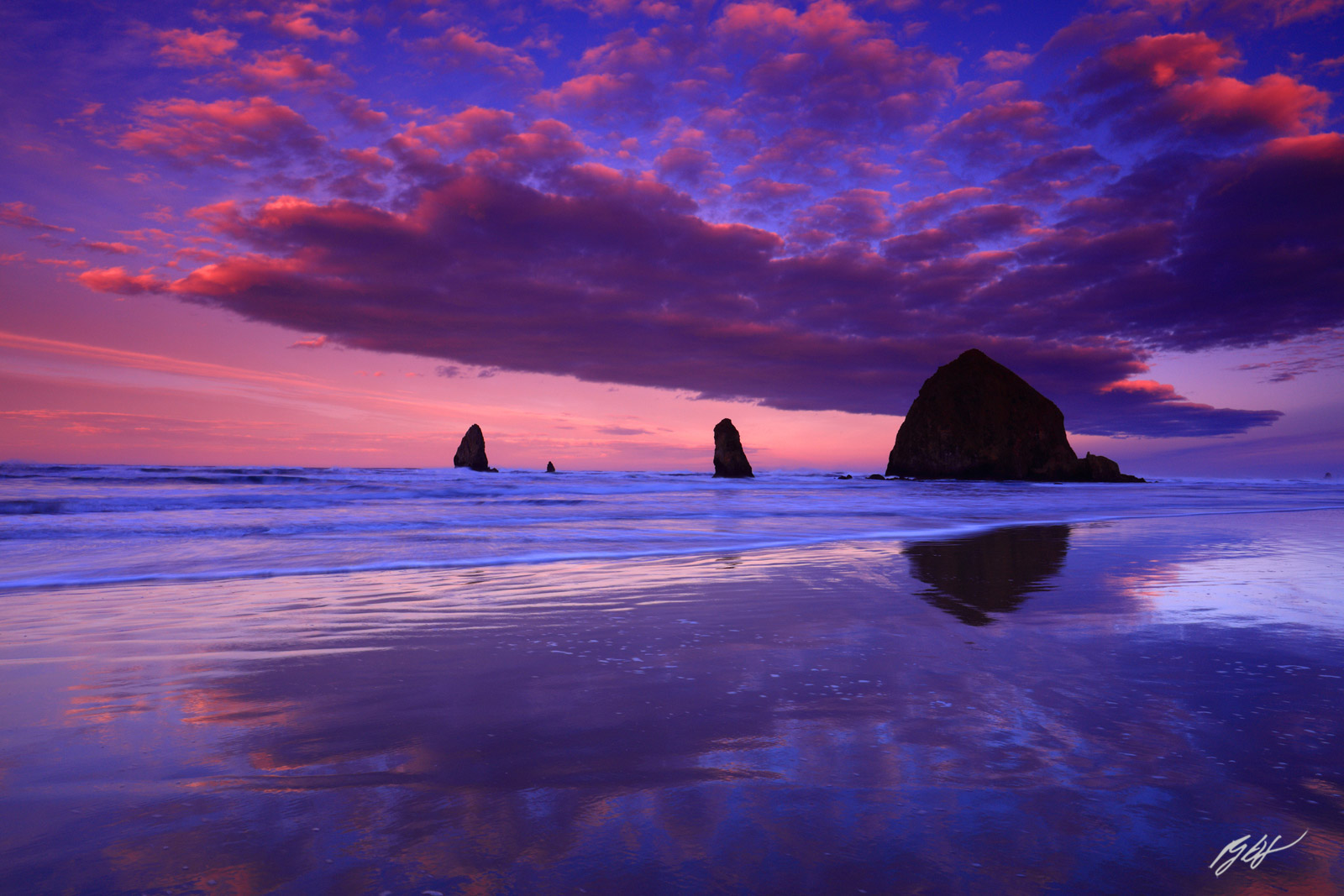 Sunrise and Cool Cloud Reflections with Haystack Rock and the Needles from Cannon Beach in Oregon