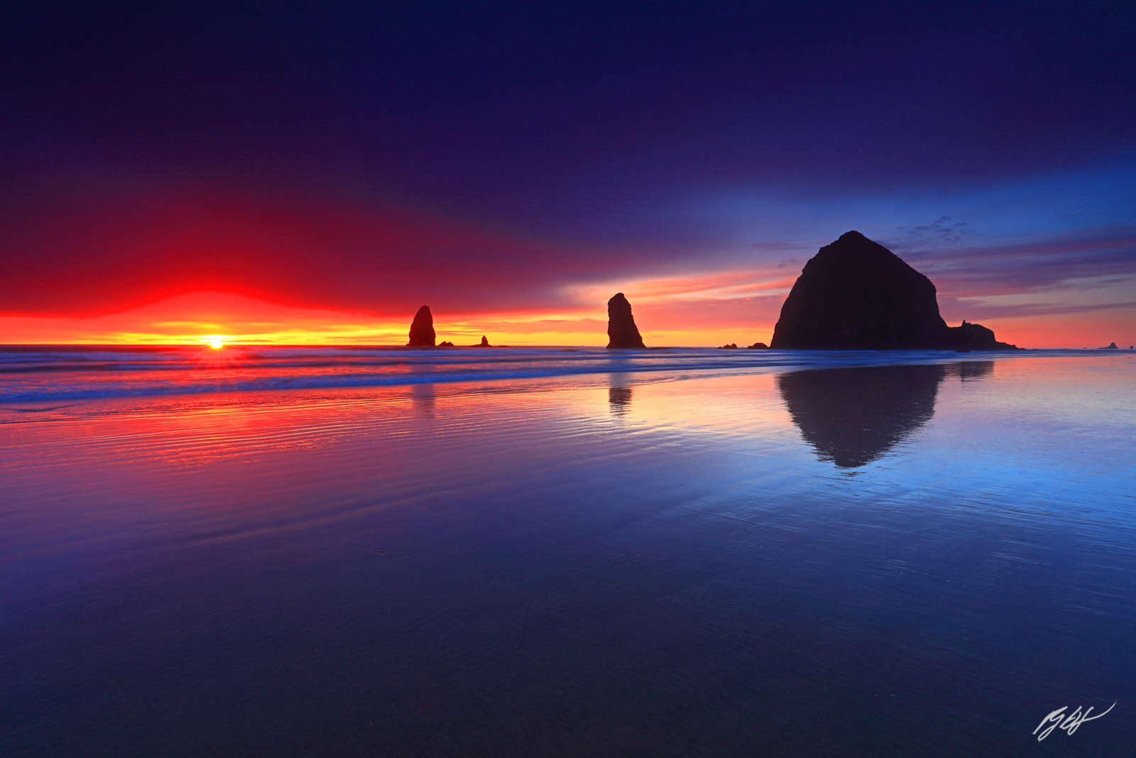 Sunset and Sunstar with Haystack Rock and the Needles from Cannon Beach in Oregon