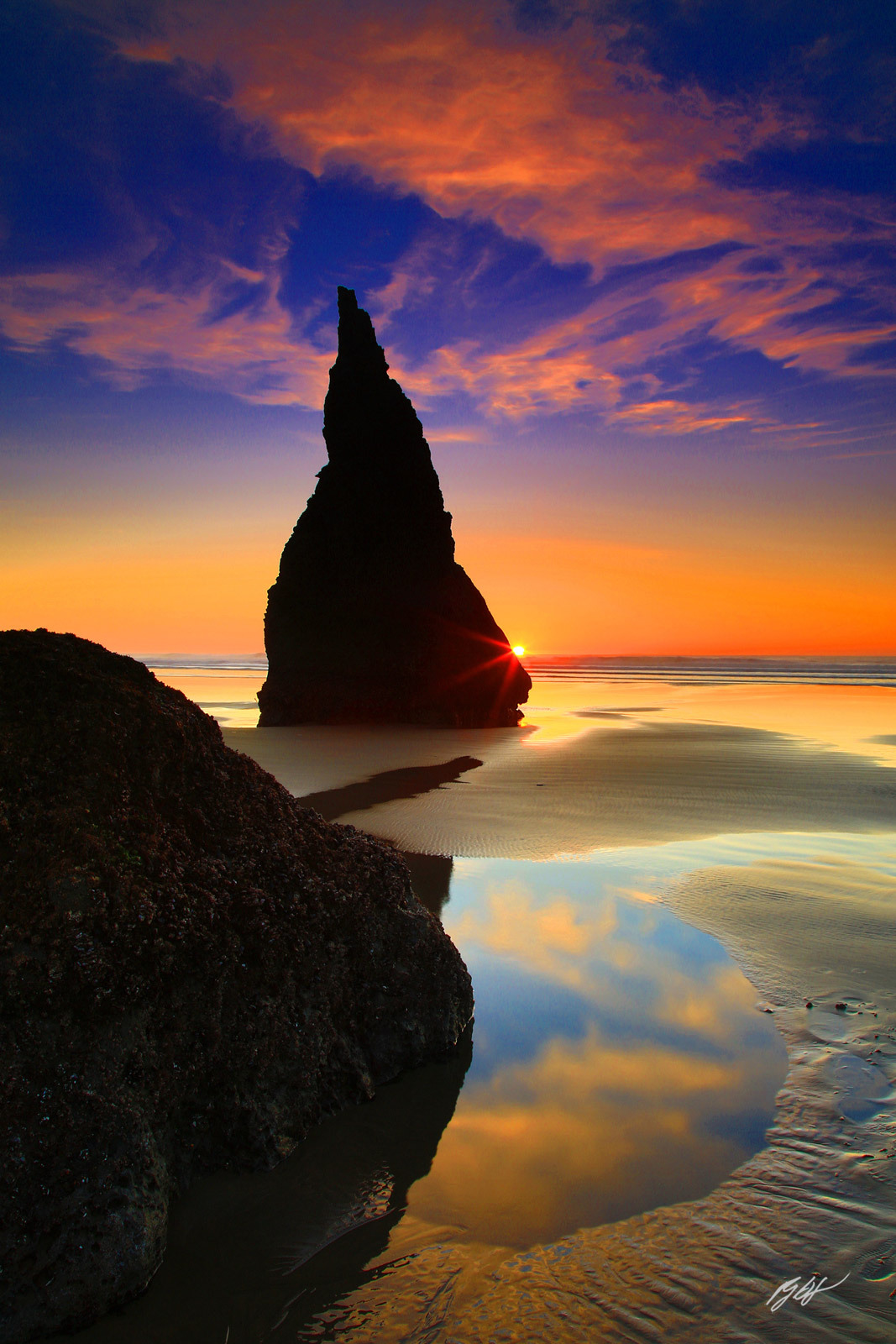 Sunset and Sunstar with the Wizards Hat from Face Rock Beach in Bandon Oregon