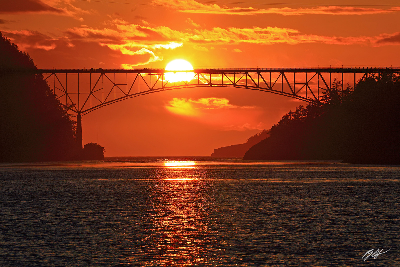 Sunset as the Sun Passes through the Deception Pass Bridge from Deception Pass State Park in Washington