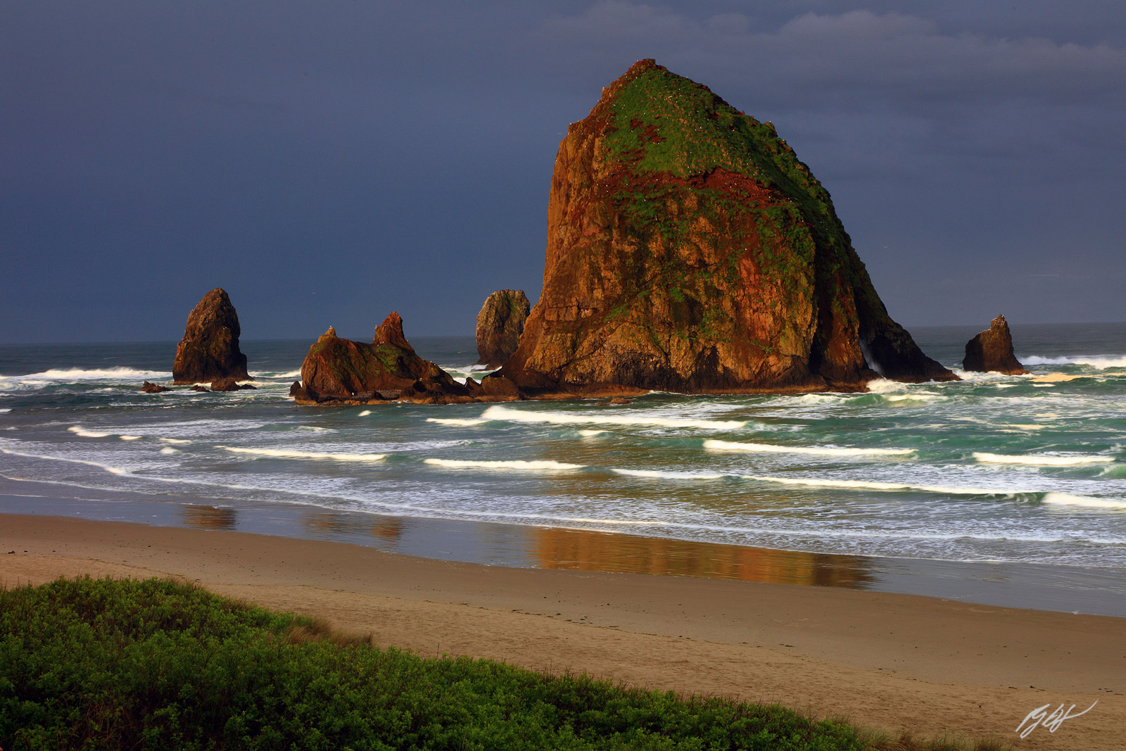 Morning Light Lights up Haystack Rock and the Needles from Cannon Beach in Oregon
