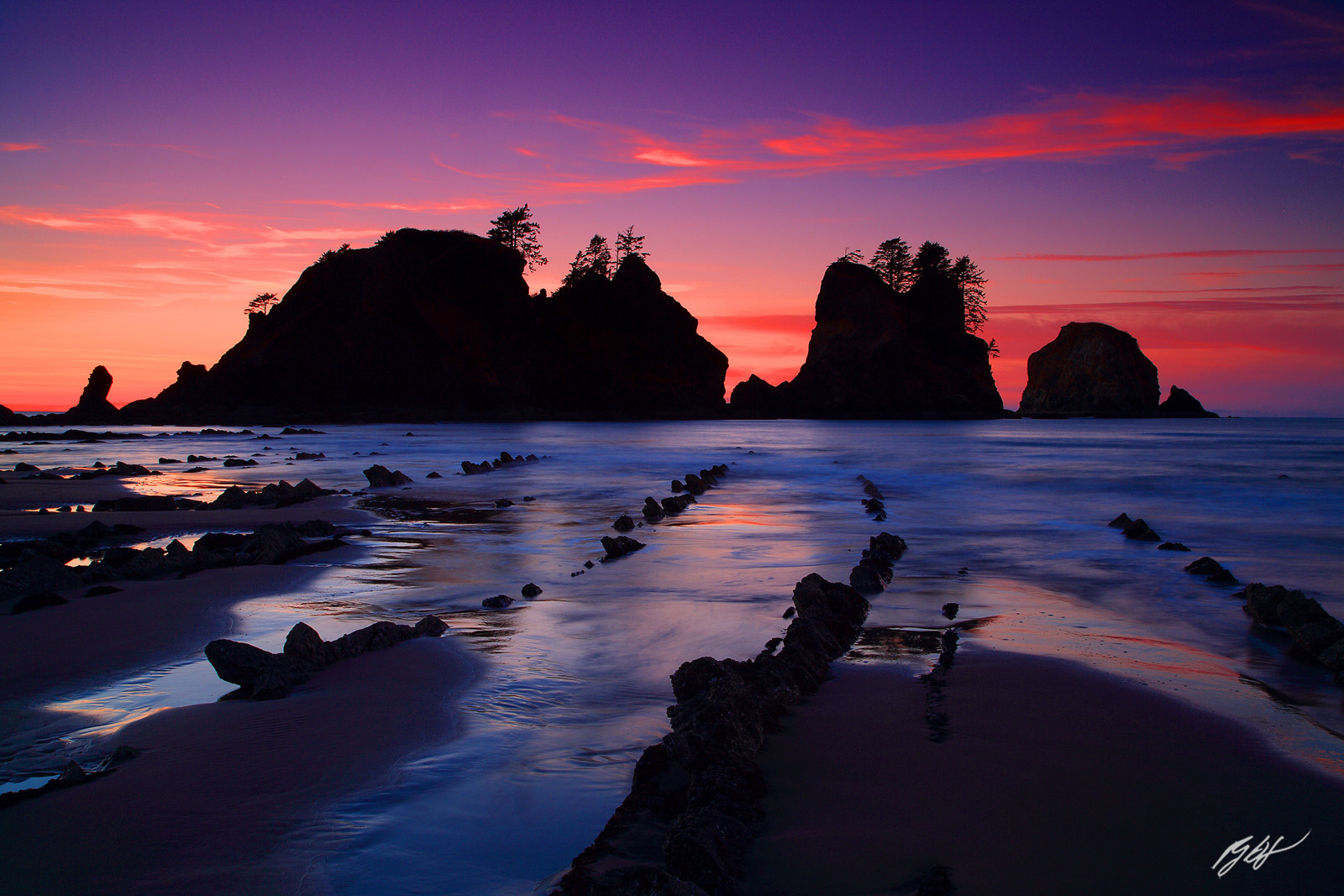 Sunset Alpenglow wit the Point of the Arches on Shi Shi Beach from Olympic National Park in Washington