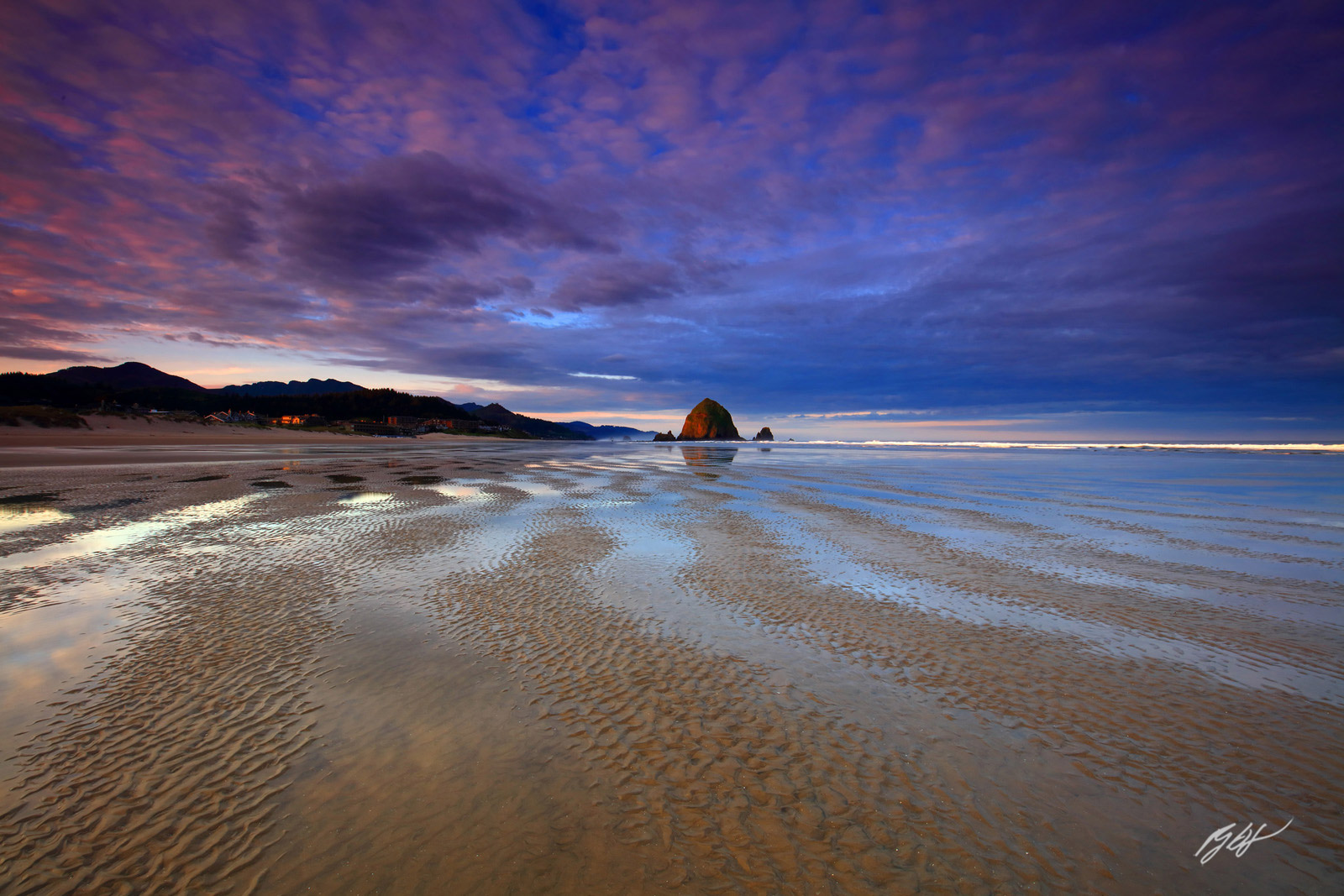 Sunrise with Haystack Rock at Low Tide Showing Designs in the Sand on Cannon Beach on the Northern Oregon Coast