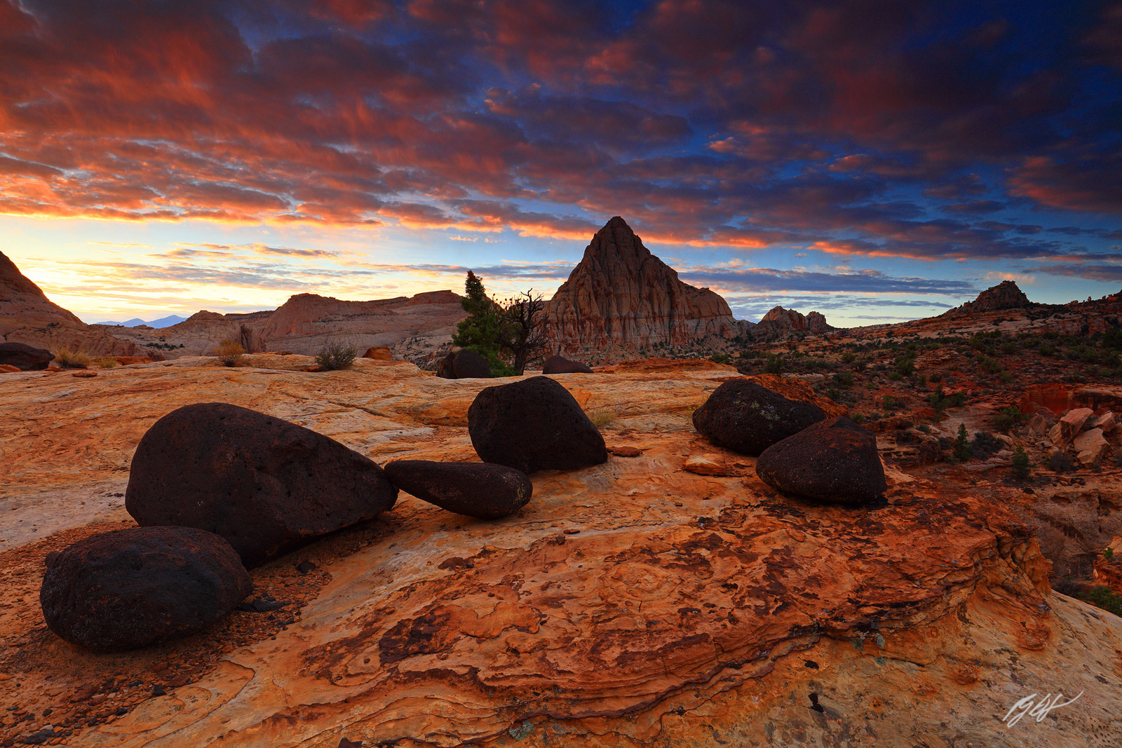 Sunrise over the Black Volcanic Boulders with Pectol's Pyramid in Capital Reef National Park in Utah
