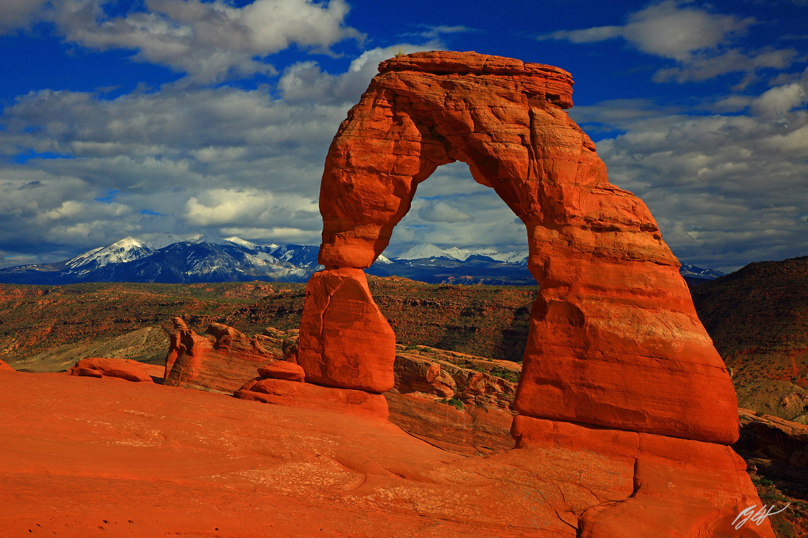 Cool Clouds and the Delicate Arch in Afternoon Light in Arches National Park in Utah