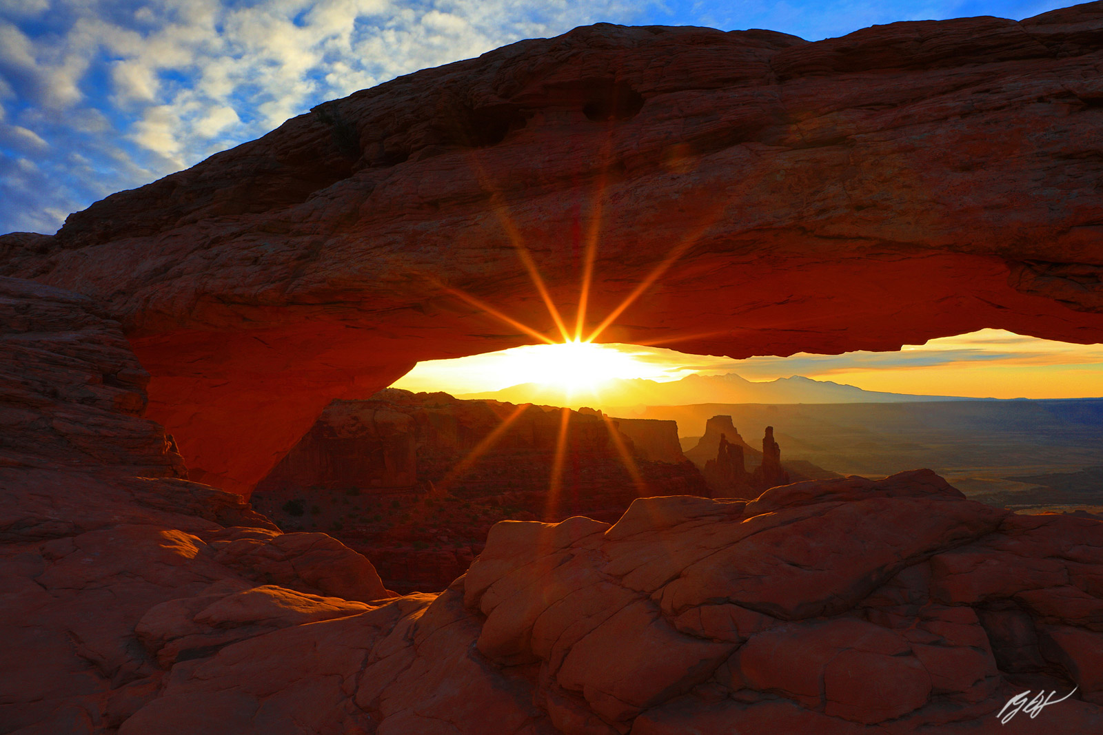 Sunrise and Sun Star under the Mesa Arch in Canyonlands National Park in Utah