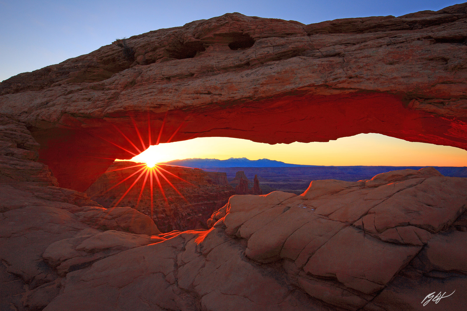 Sunrise and Sun Star Under the Mesa Arch in Canyonlands National Park in Utah