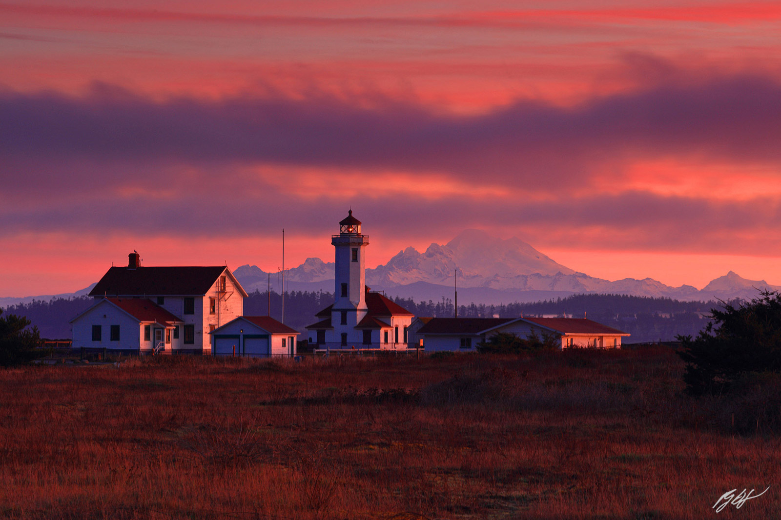 Sunset Wilson Head Lighthouse and Mt Baker in Fort Warden State Park in Washington
