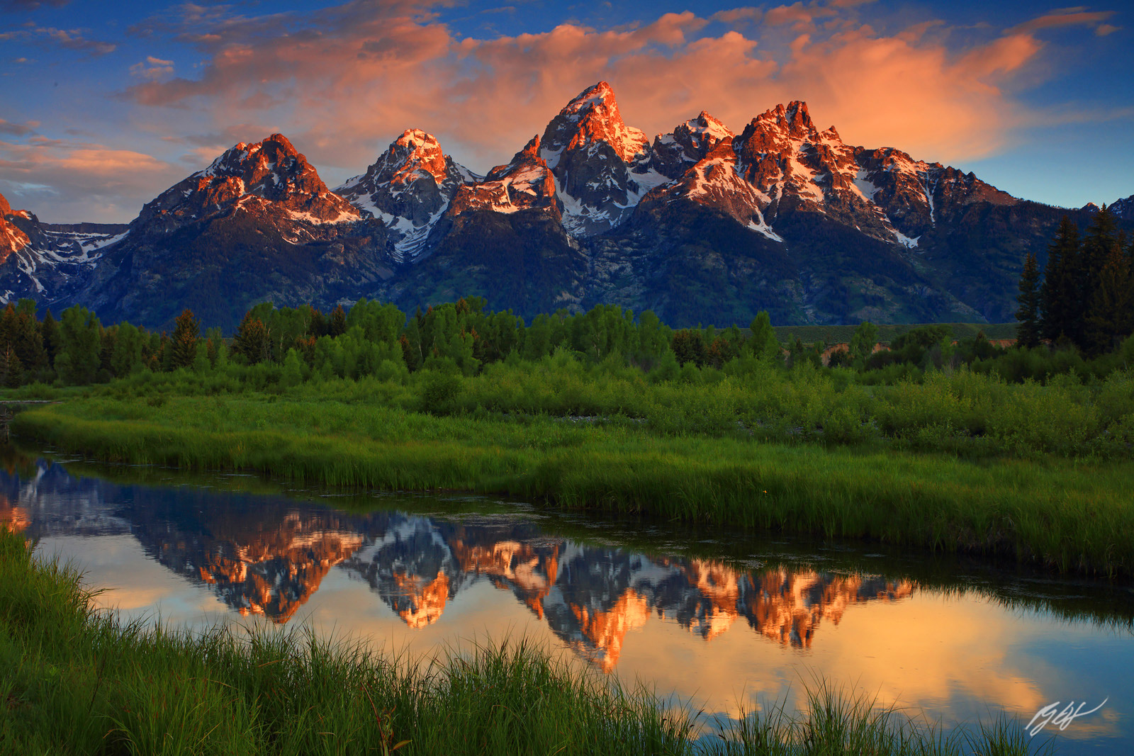 Sunrise and the Grand Tetons Reflected in Beaver Ponds at Schwabacher's Landing in Grand Teton National Park in Wyoming