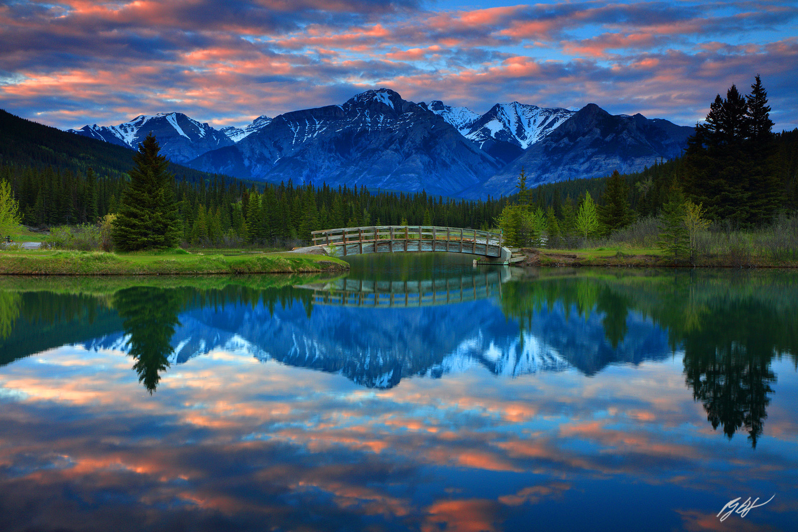 Saddle Peak and Hiking Bridge Reflected in Cascade Ponds in Banff National Park in Alberta, Canada