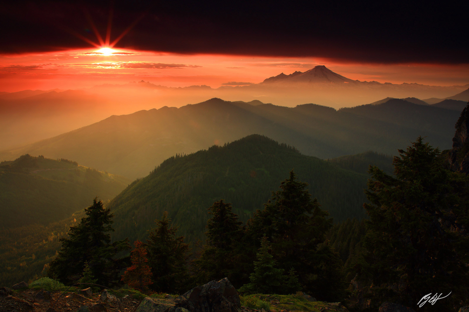 Sunset with a Sun Star Sneaking Under the Clouds with Mt Baker from the Summit of Sauk Mountain in the Mt Baker-Snoqualmie National...