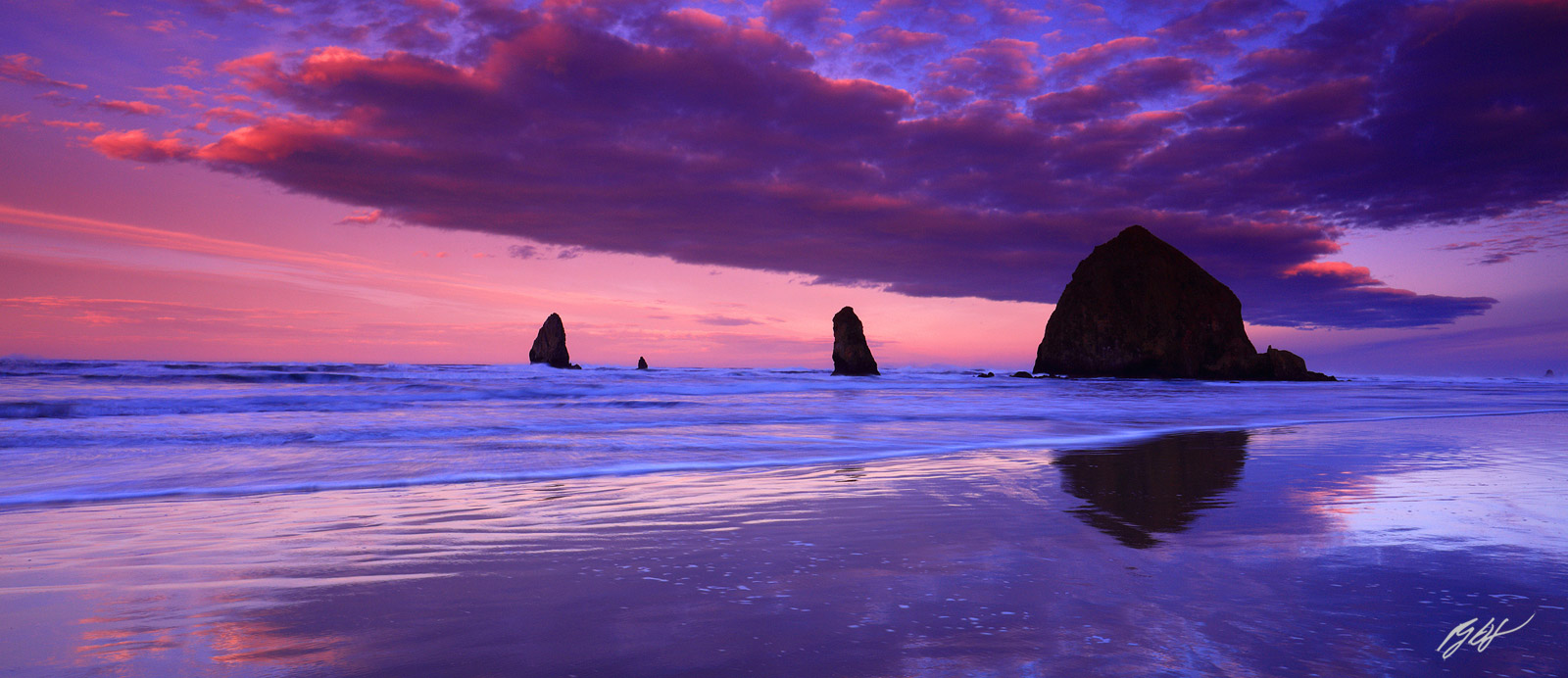 Sunrise and Clouds with Haystack Rock and the Needles from Cannon Beach on the Oregon Coast