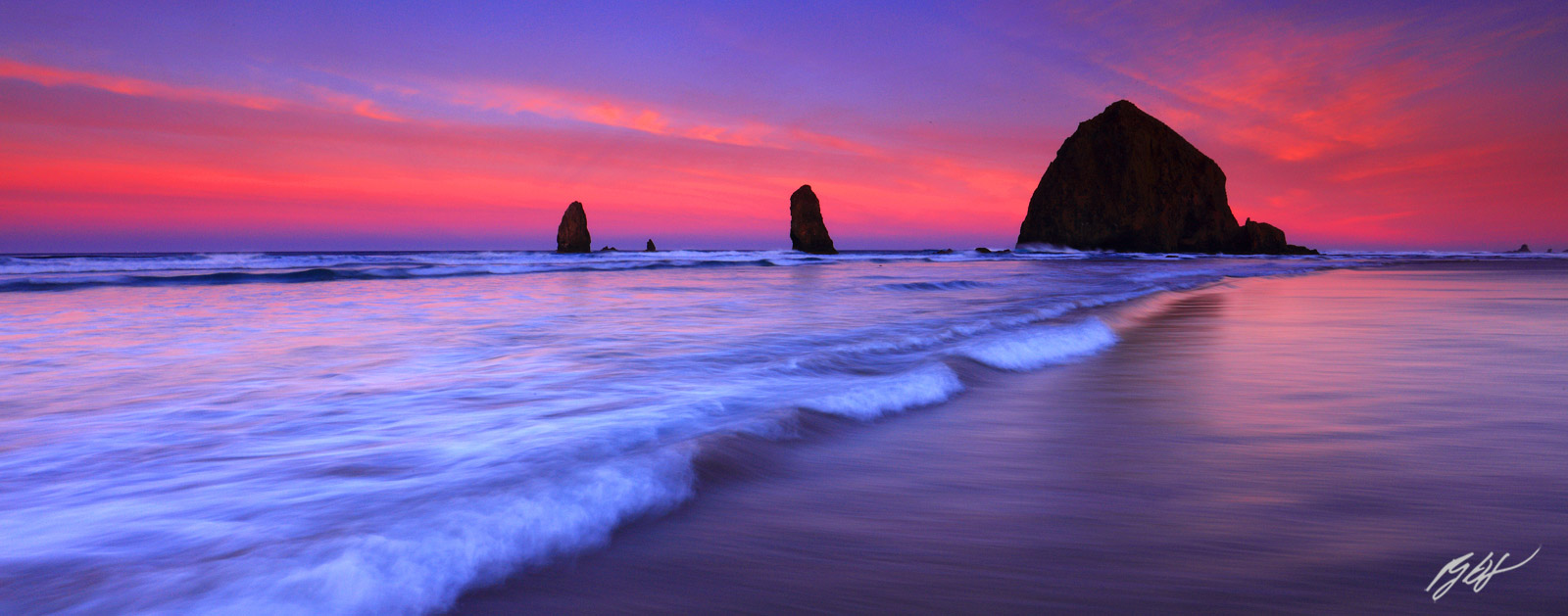 Sunrise in the Surf with Haystack Rock and the Needles from Cannon Beach on the Oregon Coast