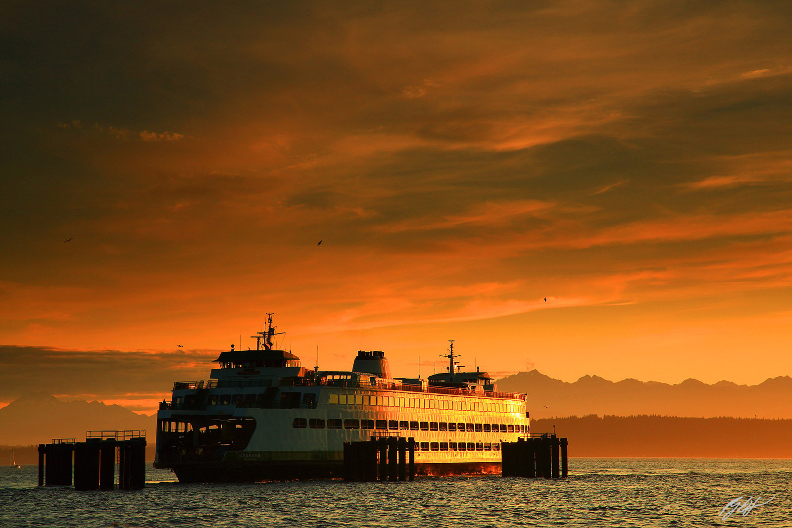 Golden Sunset and the Edmonds Ferry from Edmonds Beach in Edmonds, Washington